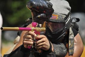 Person with the pink and gold gun, on the paintball game