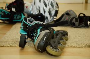 photo of roller skates and protection on the floor