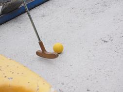 Close-up of the mini golf club and yellow golf ball