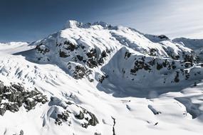 Beautiful, white, snowy, rocky mountains in light