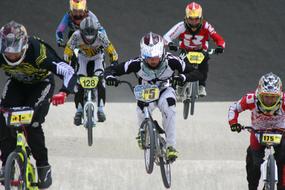 Racers on the colorful BMX bicycles, on the hills