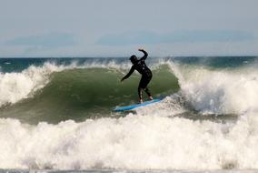 surfer in waves on a sunny day