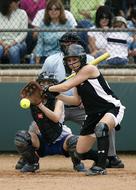 Female softball players in black and white uniform, on the competition