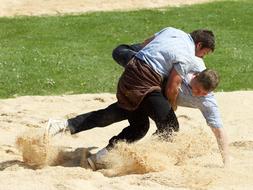 wrestling in sawdust on a sunny day