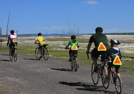 family on bicycles in yellowstone national park