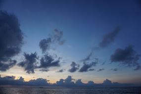 Beautiful and colorful sunrise in the sky, with the clouds, above the sea in Thailand