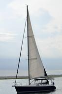 Sailboat on calm water at evening