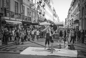 Black and white photo of the people, on the beautiful street in Lisbon, Portugal