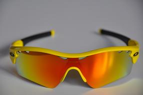 Beautiful and colorful, gradient "Oakley" sunglasses, on the white surface