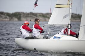 Sailboat Racing team holding ropes