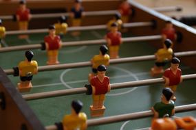 Figures of the players of the foosball table, in light