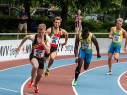 Athletes in colorful uniform, running on the colorful track