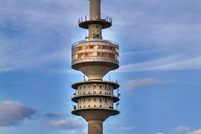 olympia tower in munich against the blue sunset sky