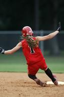 Softball Player In Uniform Slides On Base