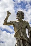 Beautiful statue near the Castel Sant'angelo, at blue sky with white clouds on background, in Rome, Italy