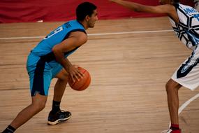 attack of a basketball player in a game in a gym