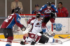 Ice hockey players and goalie, in colorful uniform, on the ice, on the competition