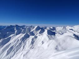 Beautiful, snowy mountains in Serfaus, Austria, at blue, gradient sky on background