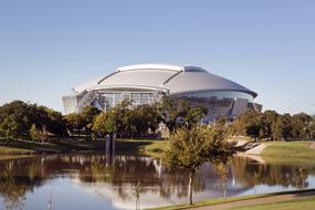 Beautiful American football stadium, among the colorful plants, near the water, in Dallas, Texas, USA