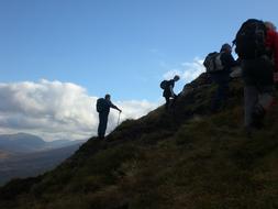 silhouettes of climbers in the mountains at dusk