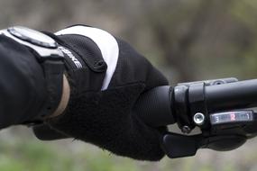 hand on the handlebars of a motorcycle close-up on a blurred background