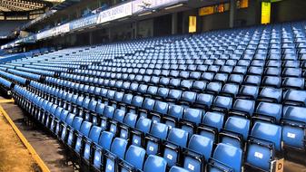 Shiny, blue seats at the stadium of Chelsea, in London, England