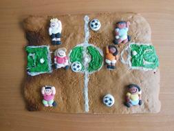 Beautiful and colorful biscuit with the players and balls on the field