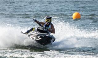 Person on the jet ski, on the water with white waves