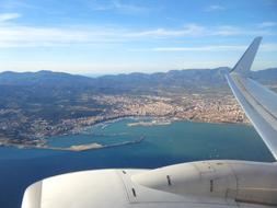 Beautiful and colorful shore of the land, with the buildings and mountains, with the view from the plane