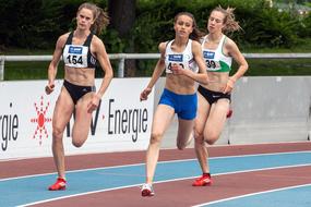 girls running on track in track and field