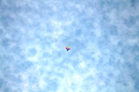 flying kite under the clouds