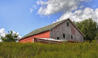 Beautiful, red, rustic barn among the green fields and trees in Ohio, USA