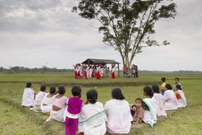 people dancing on a green field in india