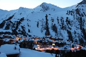 Beautiful landscape of the snowy Les Arcs, with the lights, among the mountains, in France