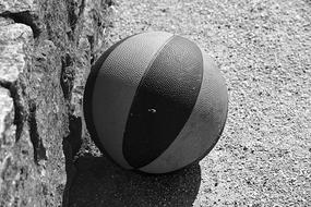 basketball ball near stone wall in black and white background