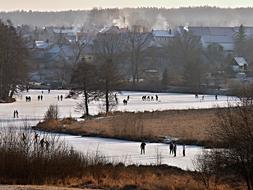 distant view of people on the pond in winter