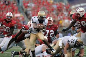 American football collision on the field in blurred background
