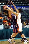 girls fight for the ball on the basketball court