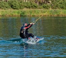Wakeboarding, man speeding on Water