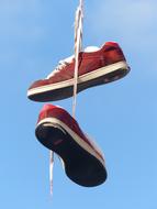 sports shoes hanging on laces