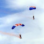 air show with parachutes in the sky