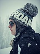 girl in a knitted hat on the mountain in winter