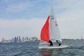 two women in Sailboat in view of modern city