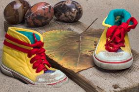 kids sports shoes on the sand