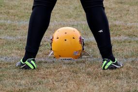 footballer legs and orange helmet