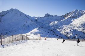 People, skiing on the beautiful, snowy mountains in Nevada, in sunlight, under the blue sky