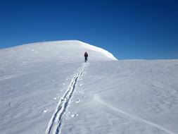 man skiing in the snowy sunny mountains