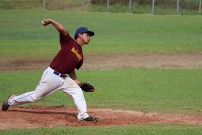 Male baseball player, on the green and brown field, on the competition