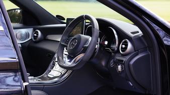Beautiful interior of the shiny Mercedes car, with the steering wheel and screen