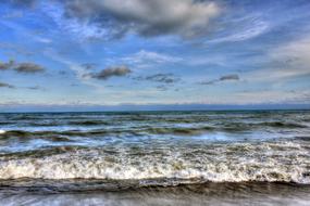 cloudy sky above the surf on lake michigan